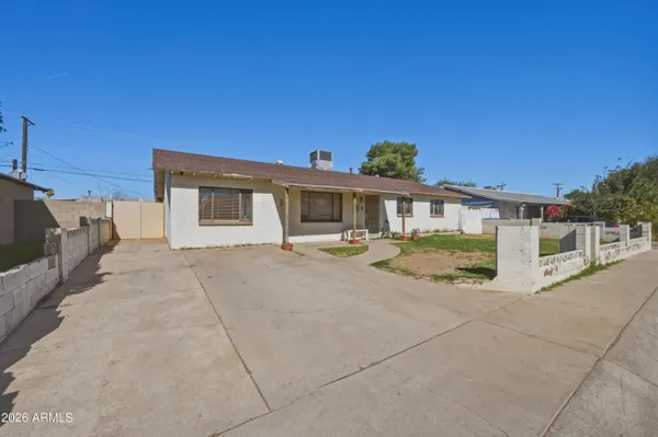 a view of a hallway with wooden floor and chandelier