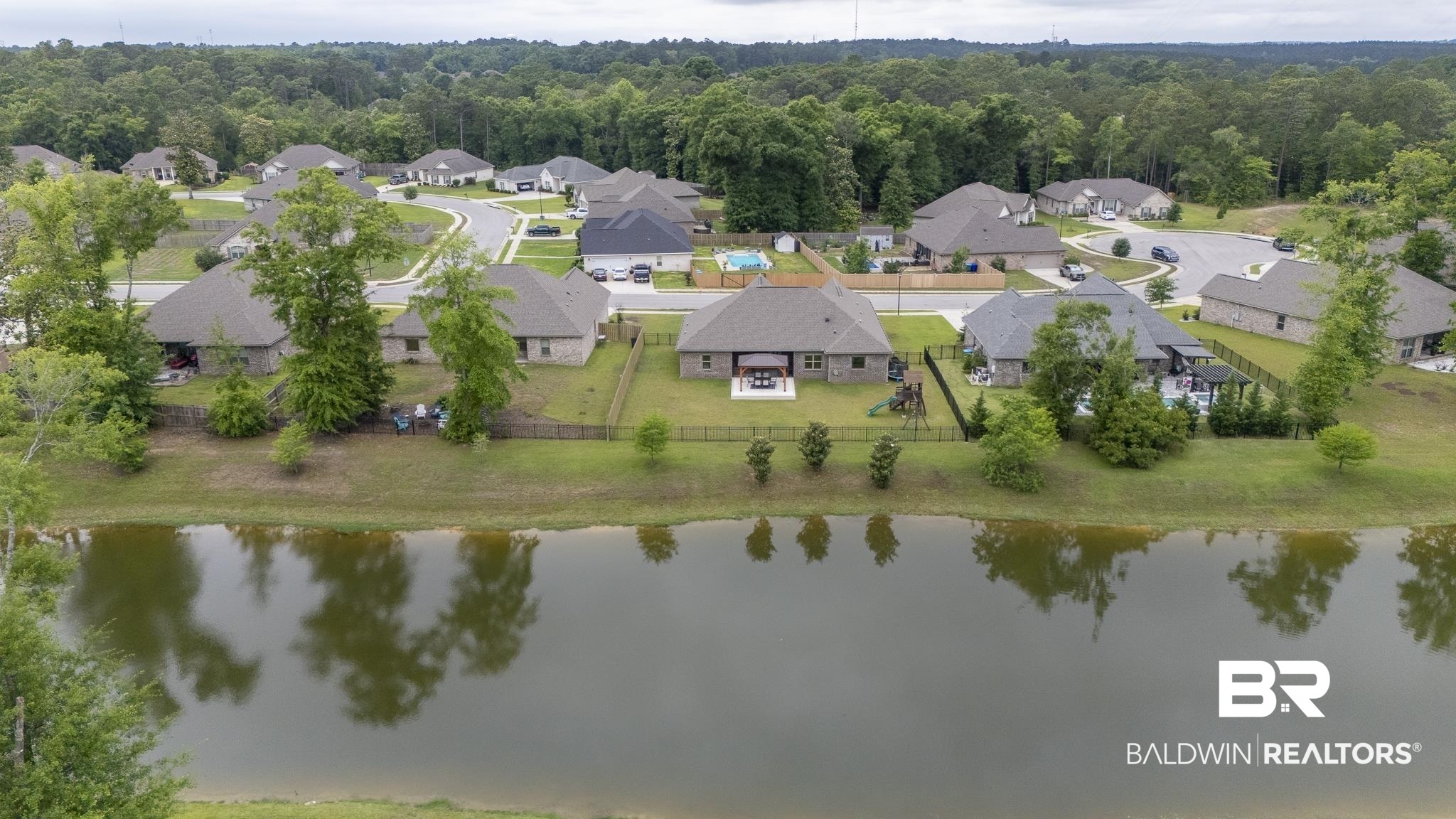 12672 Squirrel Drive Daphne, AL 36527 - Photo 46 of 49 Lakeside community featuring single-story homes with fenced backyards, mature trees, and paved roads