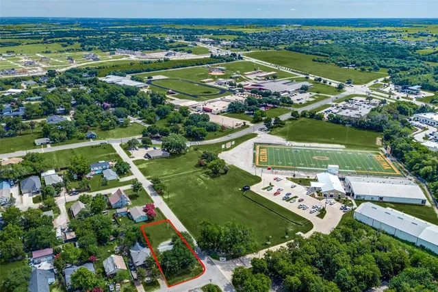 an aerial view of a city with lots of residential buildings and mountain view in back