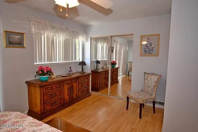 a bed sitting in a bedroom next to a window