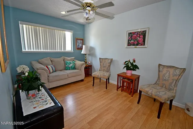 a living room with furniture a chandelier and a window