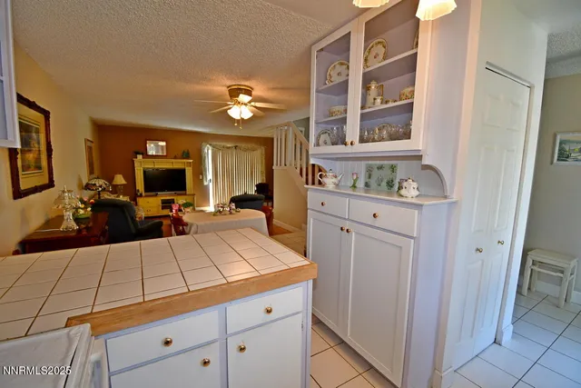 a large kitchen with kitchen island granite countertop a stove a sink and a refrigerator