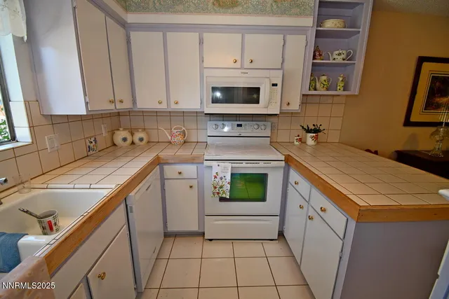 a living room with fireplace furniture and a flat screen tv