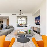 a living room with furniture a couch and a chandelier