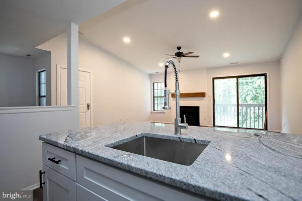 a kitchen with a sink and a fireplace