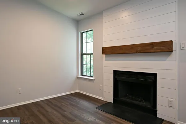 a living room with a fireplace and a table