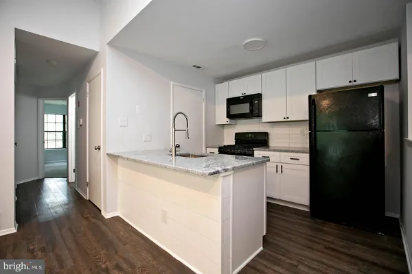 a kitchen with stainless steel appliances a refrigerator stove and microwave