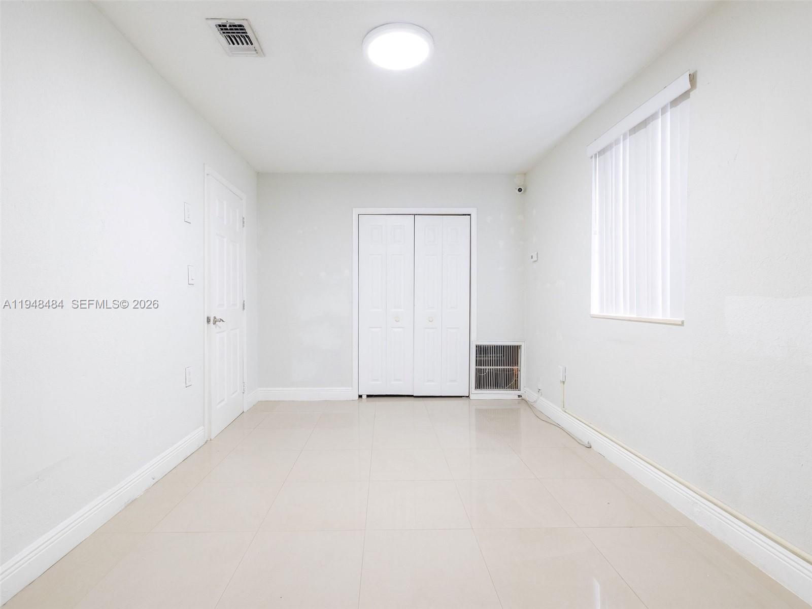 201 East 44th Street Hialeah, FL 33013 - Photo 34 of 39 an empty room with a empty space and windows