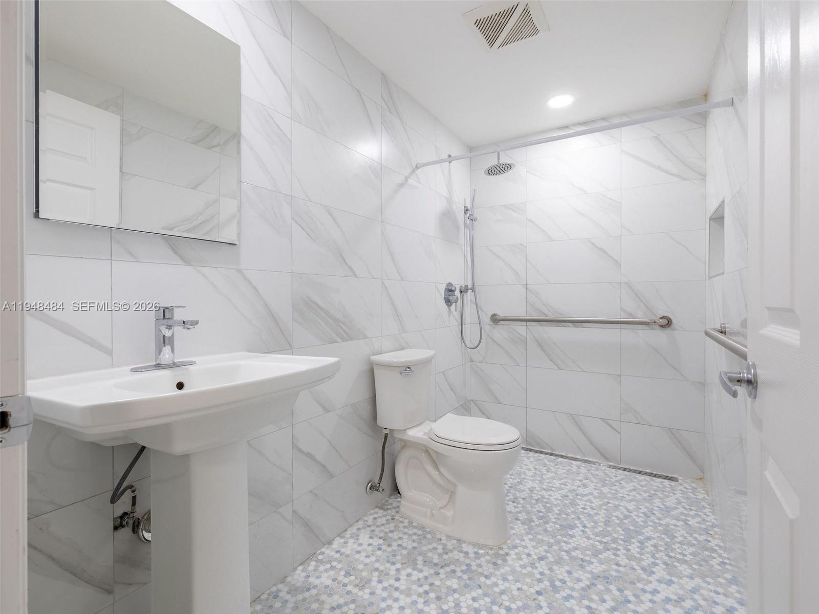 201 East 44th Street Hialeah, FL 33013 - Photo 34 of 41 a bathroom with a sink toilet a mirror and shower