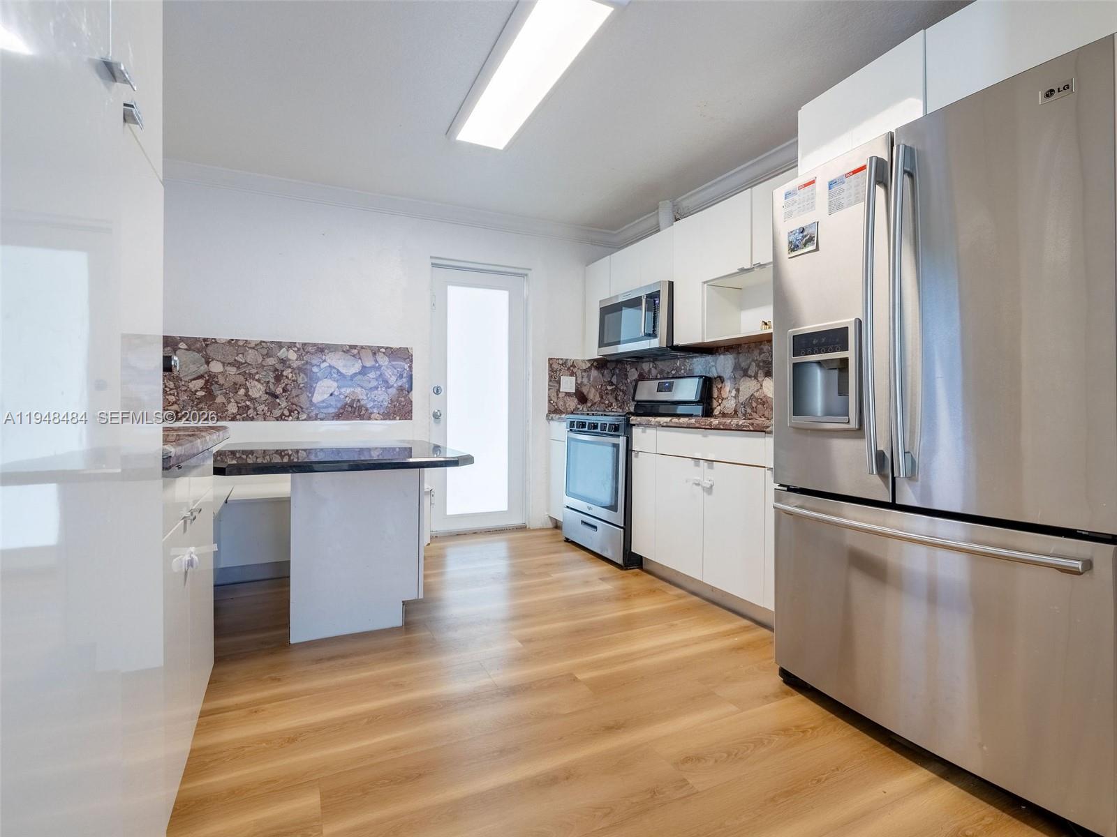 201 East 44th Street Hialeah, FL 33013 - Photo 6 of 39 a kitchen with stainless steel appliances a refrigerator sink and microwave