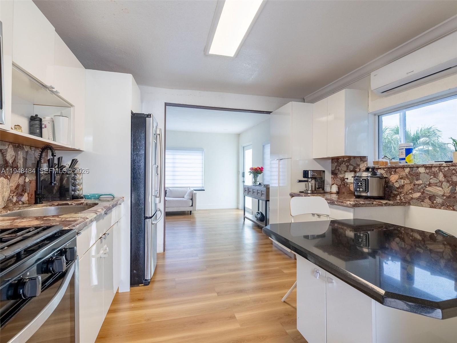 201 East 44th Street Hialeah, FL 33013 - Photo 8 of 39 a kitchen with stainless steel appliances granite countertop a sink stove and cabinets