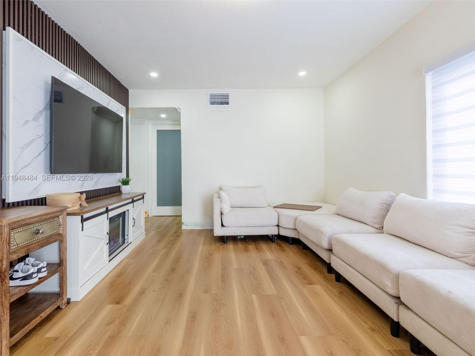 201 East 44th Street Hialeah, FL 33013 - Photo 9 of 39 a living room with furniture and a flat screen tv