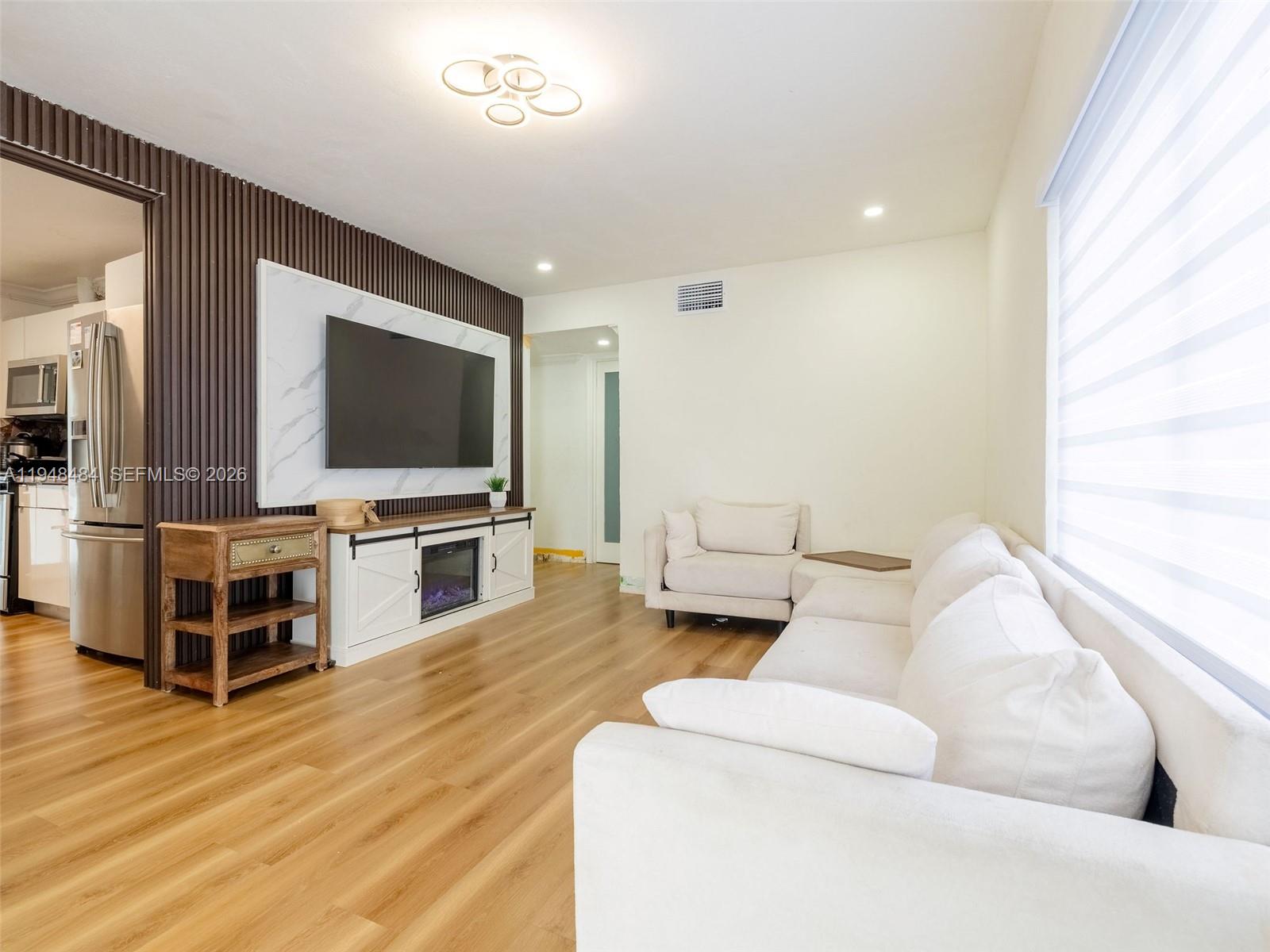 201 East 44th Street Hialeah, FL 33013 - Photo 10 of 39 a living room with furniture and a flat screen tv