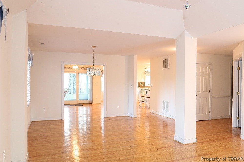 97 Barnes View Lane Kilmarnock, VA 22482 - Photo 7 of 20 Open great room with dining are, hardwood floor, and views to the water.