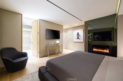 a bedroom with a large bed and a tv