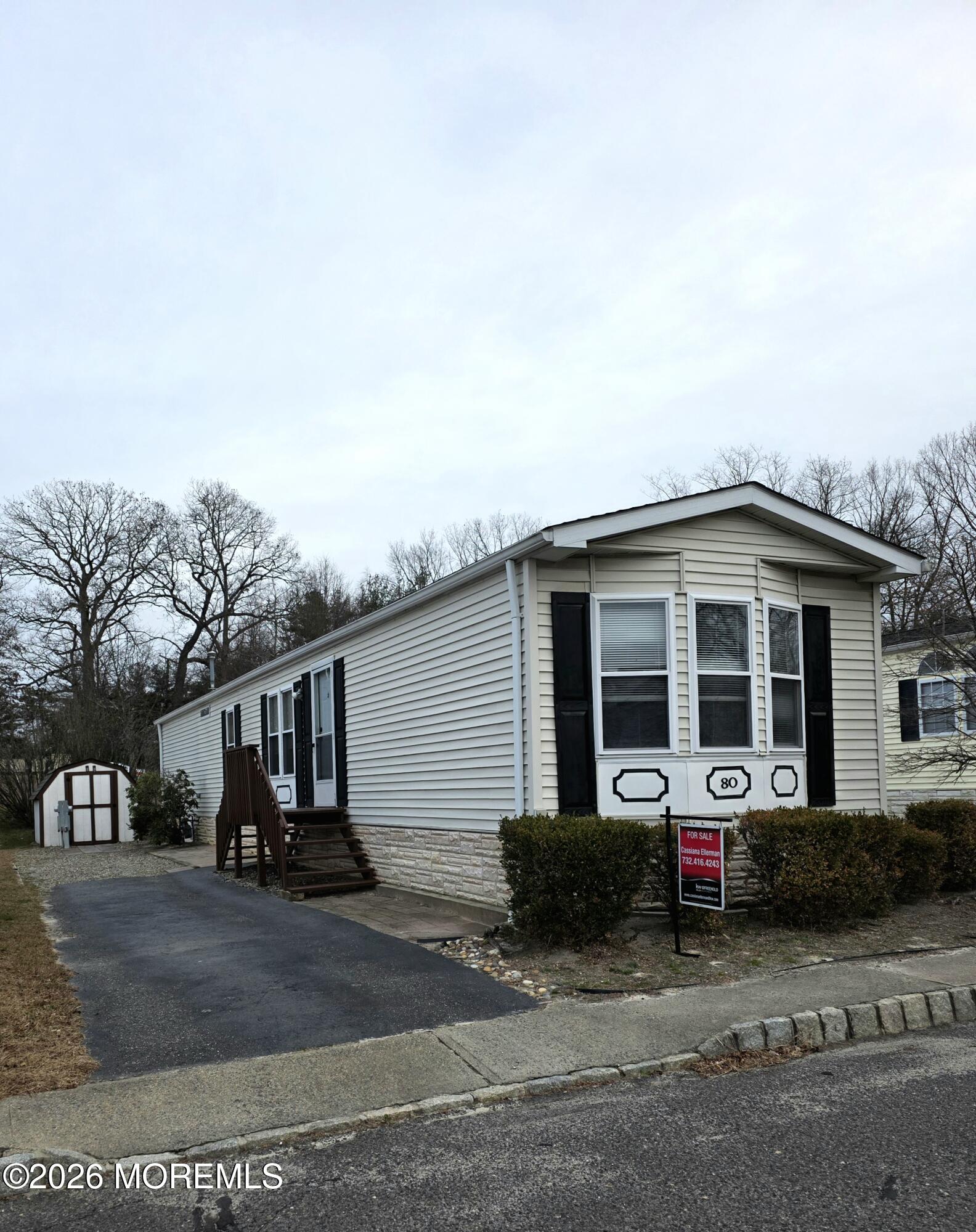 80 Secretariat Street, Unit 66 Howell, NJ 07731 - Photo 2 of 25 a front view of a house with a yard garage and garage