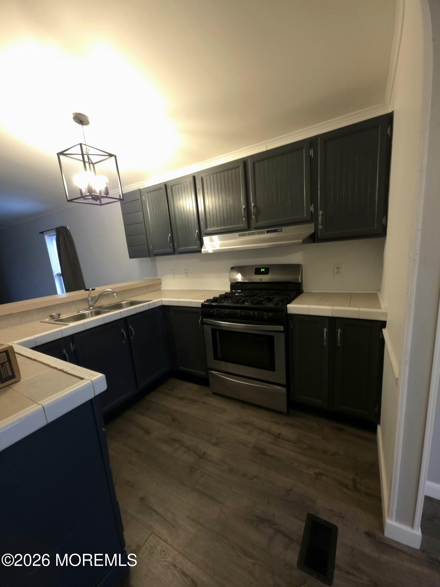 80 Secretariat Street, Unit 66 Howell, NJ 07731 - Photo 5 of 25 a kitchen with stainless steel appliances a stove a sink and a refrigerator
