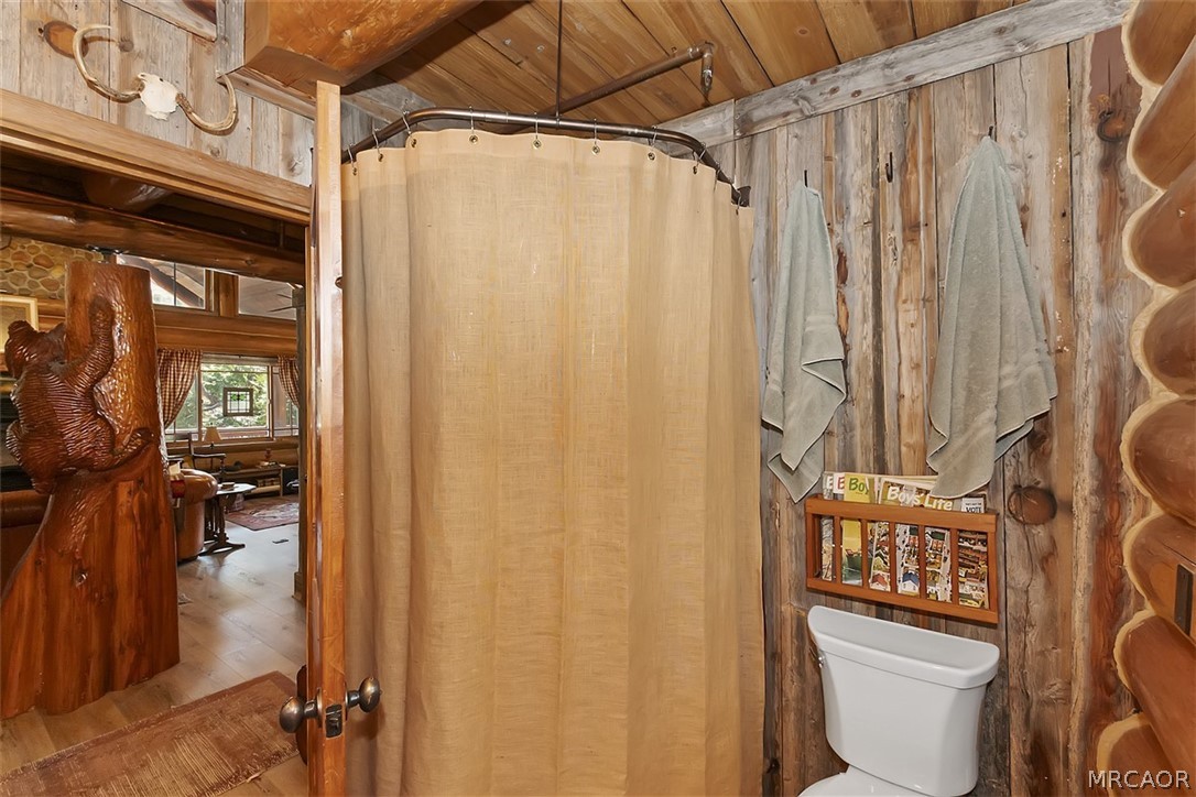 29632 Hook Creek Road Cedar Glen, CA 92321 - Photo 20 of 43 a bathroom with a toilet and shower curtain