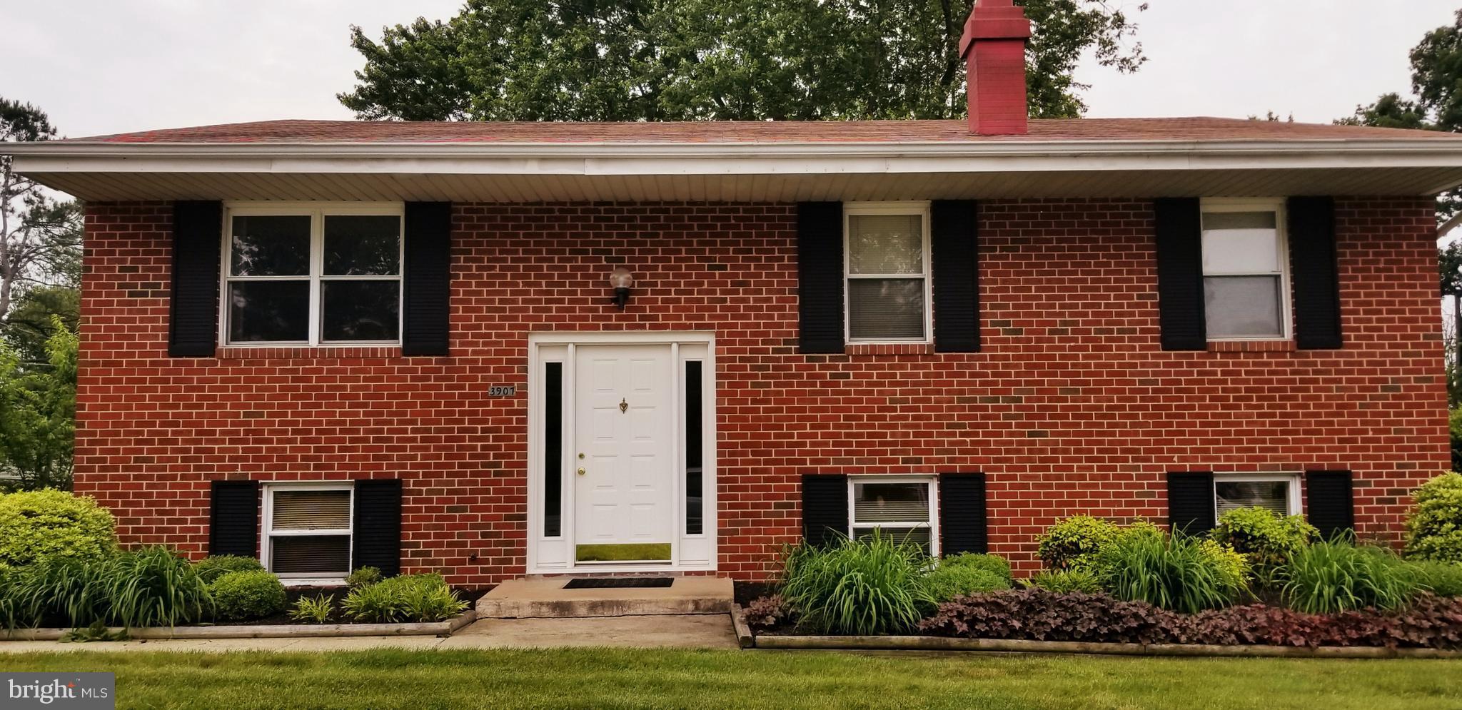 3907 Sybil Road Randallstown, MD 21133 - Photo 2 of 30 a front view of a house with a yard