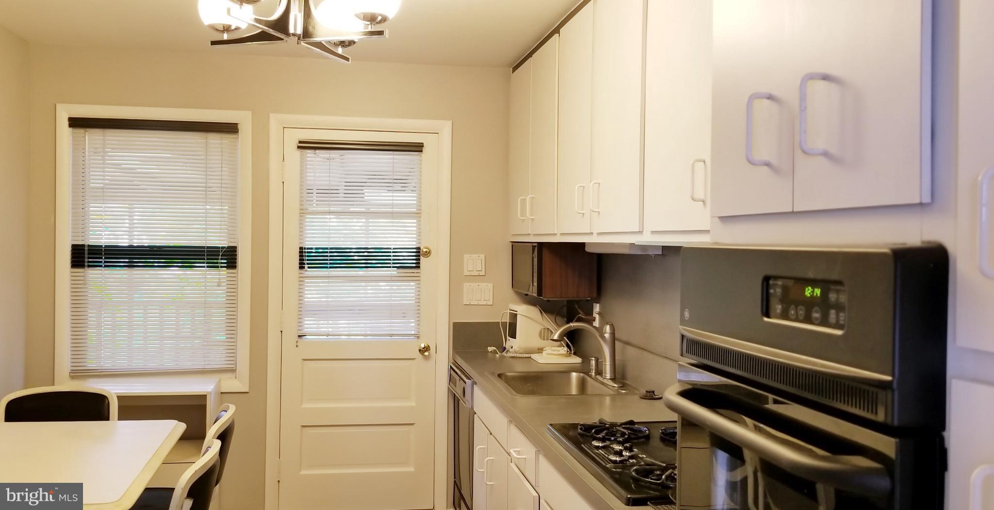 3907 Sybil Road Randallstown, MD 21133 - Photo 12 of 30 a kitchen with a sink and a stove top oven