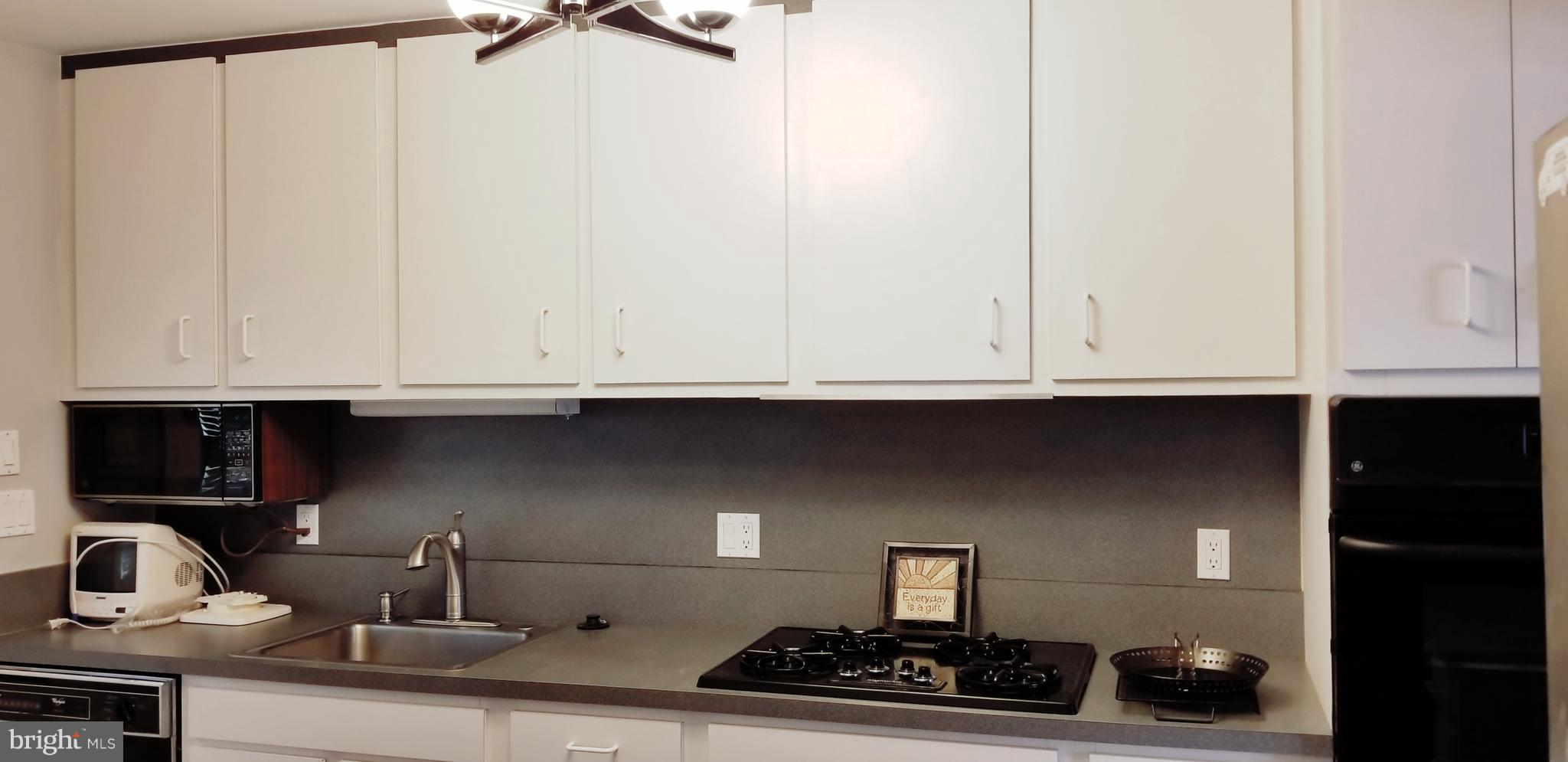 3907 Sybil Road Randallstown, MD 21133 - Photo 13 of 30 a kitchen with a sink and cabinets