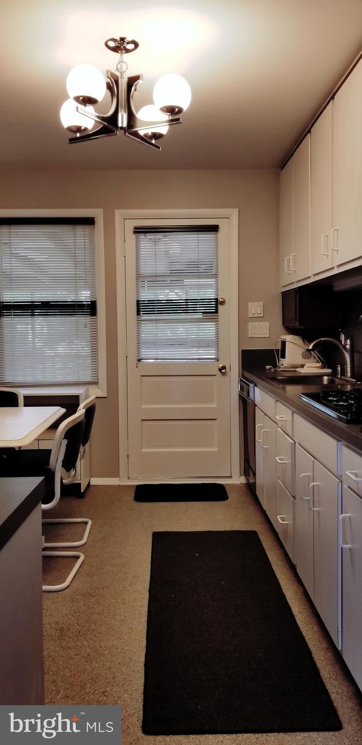 3907 Sybil Road Randallstown, MD 21133 - Photo 14 of 30 a kitchen with a refrigerator and a stove top oven