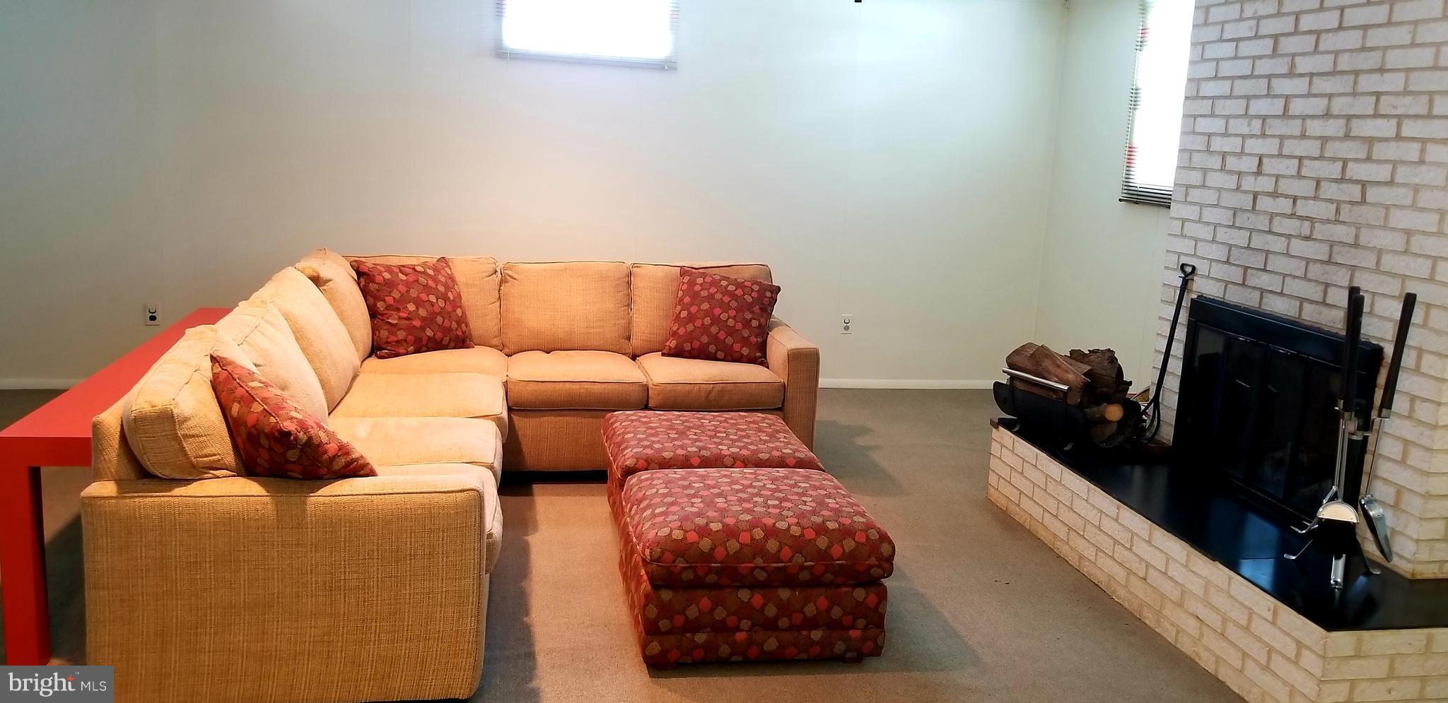 3907 Sybil Road Randallstown, MD 21133 - Photo 24 of 30 a living room with furniture and a fireplace