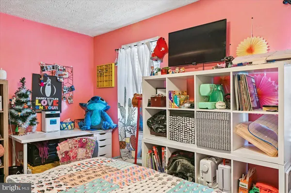 a bedroom with a bed and a book shelf