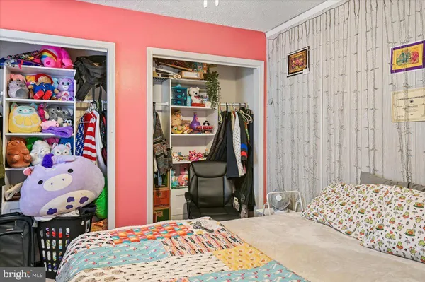 a bedroom with a bed and a bookshelf