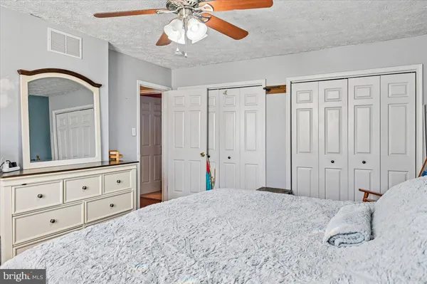 a bedroom with a large bed and a chandelier