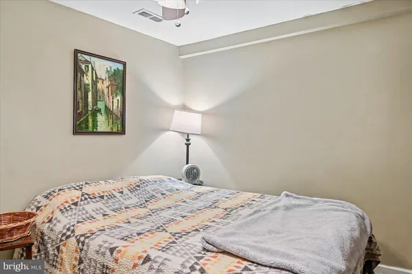 a bedroom with a bed and a lamp