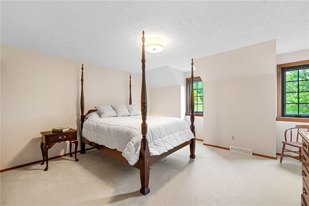 2972 East Hardies Road Gibsonia, PA 15044 - Photo 21 of 42 a spacious bedroom with a bed a chair and next to a window