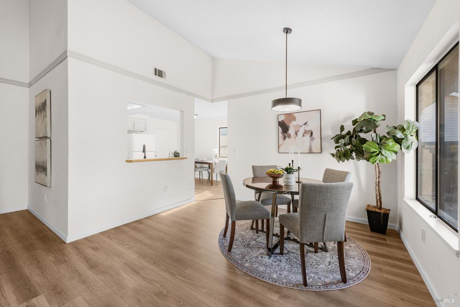 107 Inyo Court Vacaville, CA 95687 - Photo 11 of 49 a dining room with furniture potted plants and wooden floor