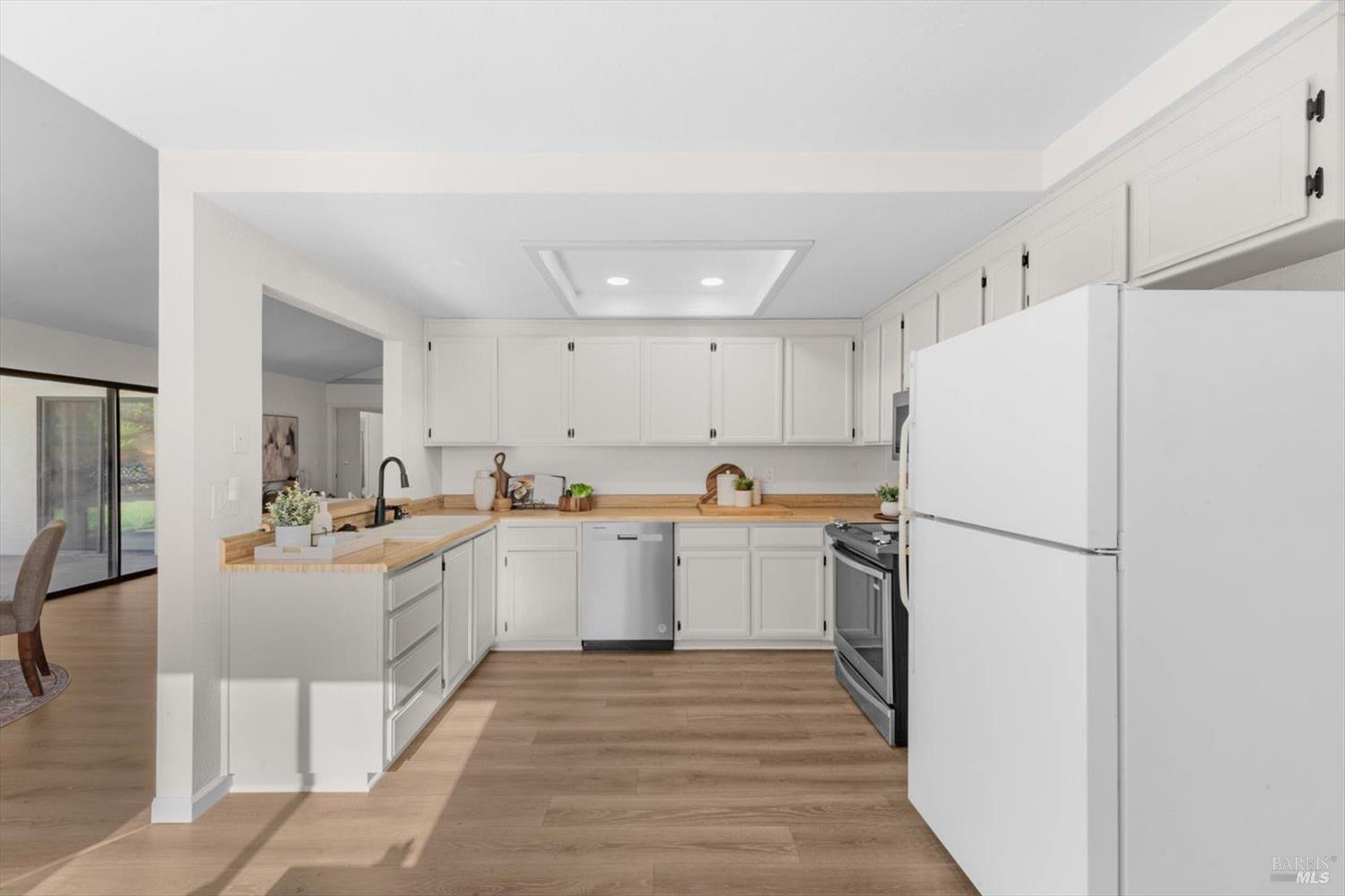 107 Inyo Court Vacaville, CA 95687 - Photo 12 of 49 a kitchen with refrigerator and cabinets