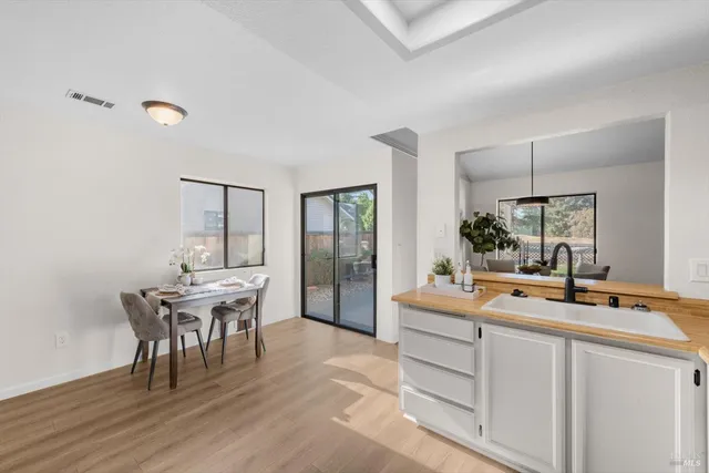 a room with a table chairs and entryway