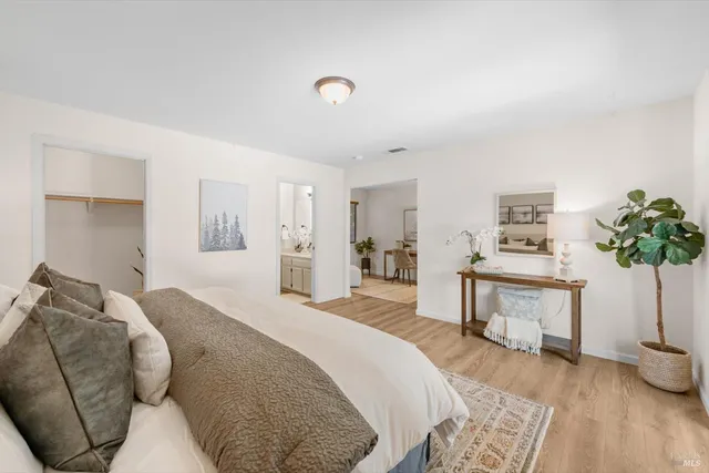 a spacious bedroom with a bed and a table in it