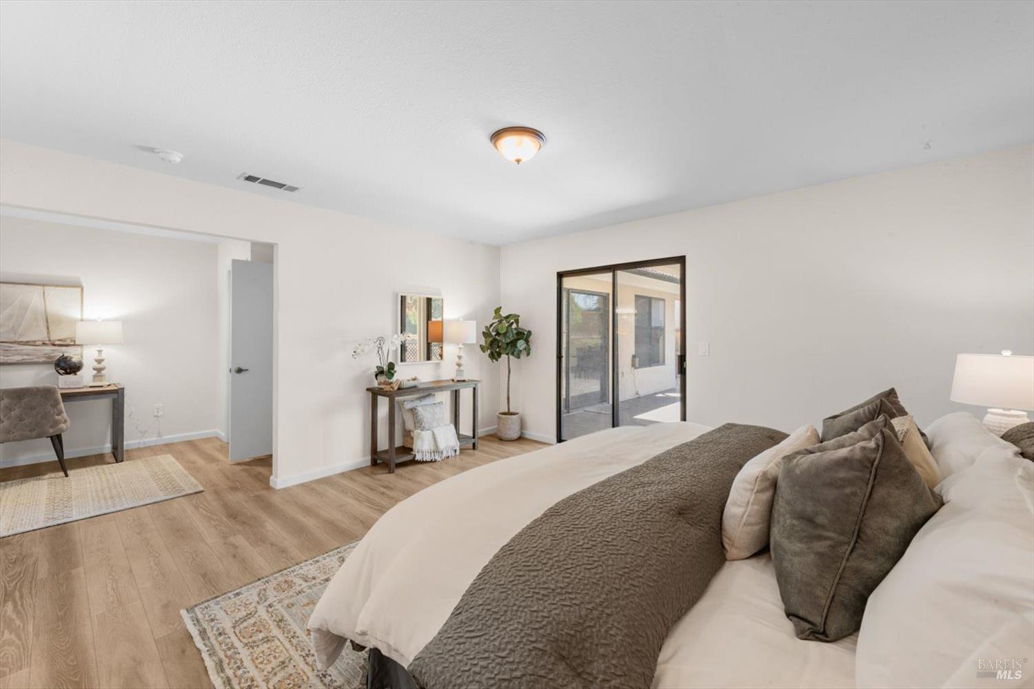 107 Inyo Court Vacaville, CA 95687 - Photo 20 of 49 a bedroom with a bed and a view of living room