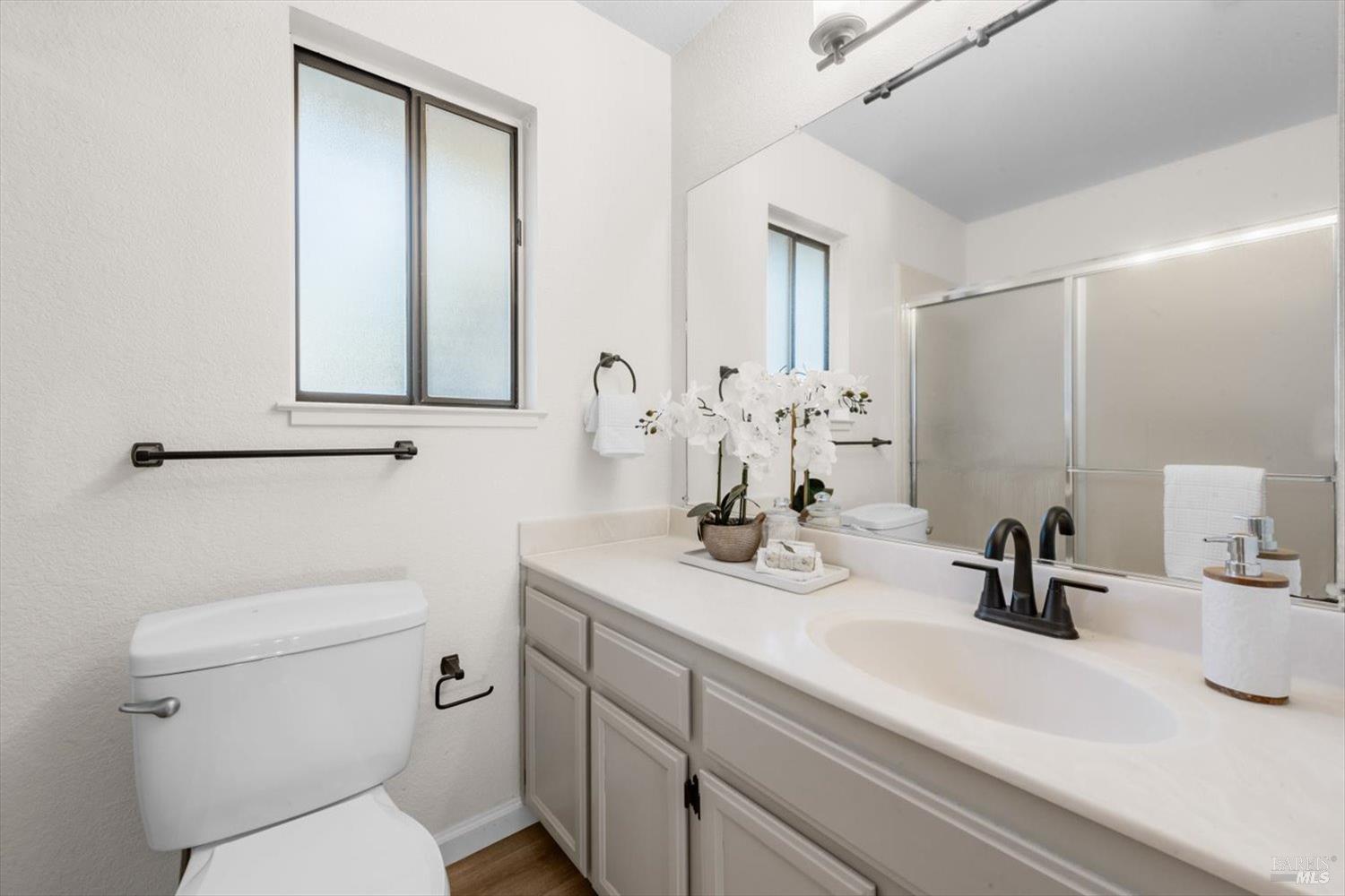 107 Inyo Court Vacaville, CA 95687 - Photo 23 of 49 a bathroom with a sink a toilet and mirror