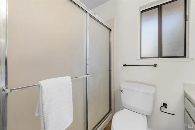 a white toilet sitting next to a bathroom sink