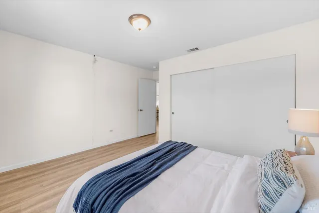 a bedroom with a bed and a lamp