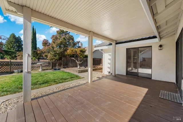 a view of a porch with wooden floor and garden
