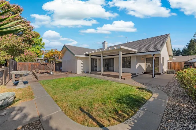 a view of a house with backyard porch and sitting area