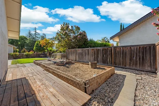 a view of a wooden floor with a bench in a yard