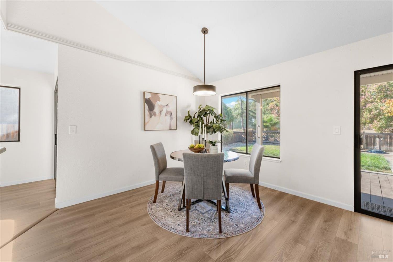 107 Inyo Court Vacaville, CA 95687 - Photo 10 of 49 a dining room with furniture a window and wooden floor