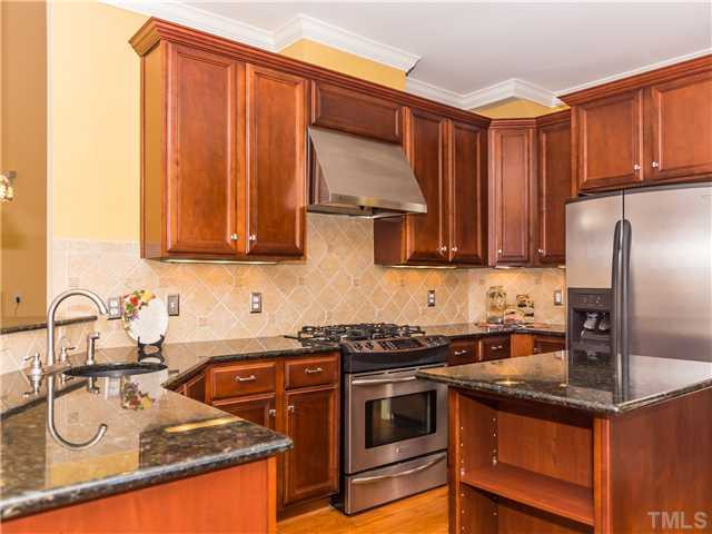 8677 Barrett Ridge Road Wake Forest, NC 27587 - Photo 6 of 25 Granite counters, tile back splash, center island and more all combine to make this a dream kitchen! Kitchen