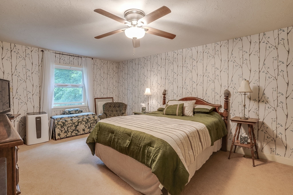49 S Road Templeton, MA 01468 - Photo 21 of 33 a bedroom with a bed and a chandelier