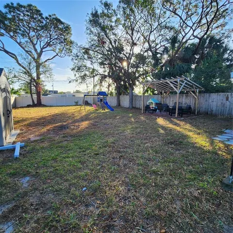 a view of a yard with palm trees