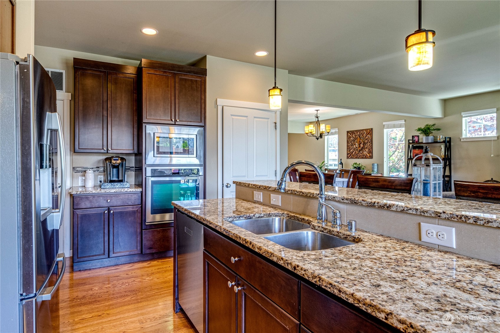 4315 229th Place Southeast Bothell, WA 98021 - Photo 16 of 40 a kitchen with stainless steel appliances granite countertop a sink refrigerator and cabinets