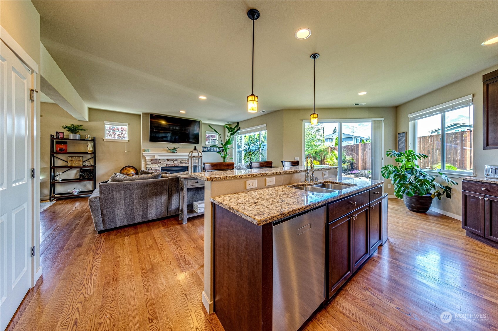 4315 229th Place Southeast Bothell, WA 98021 - Photo 17 of 40 a kitchen with stainless steel appliances granite countertop wooden floors and a view of living room