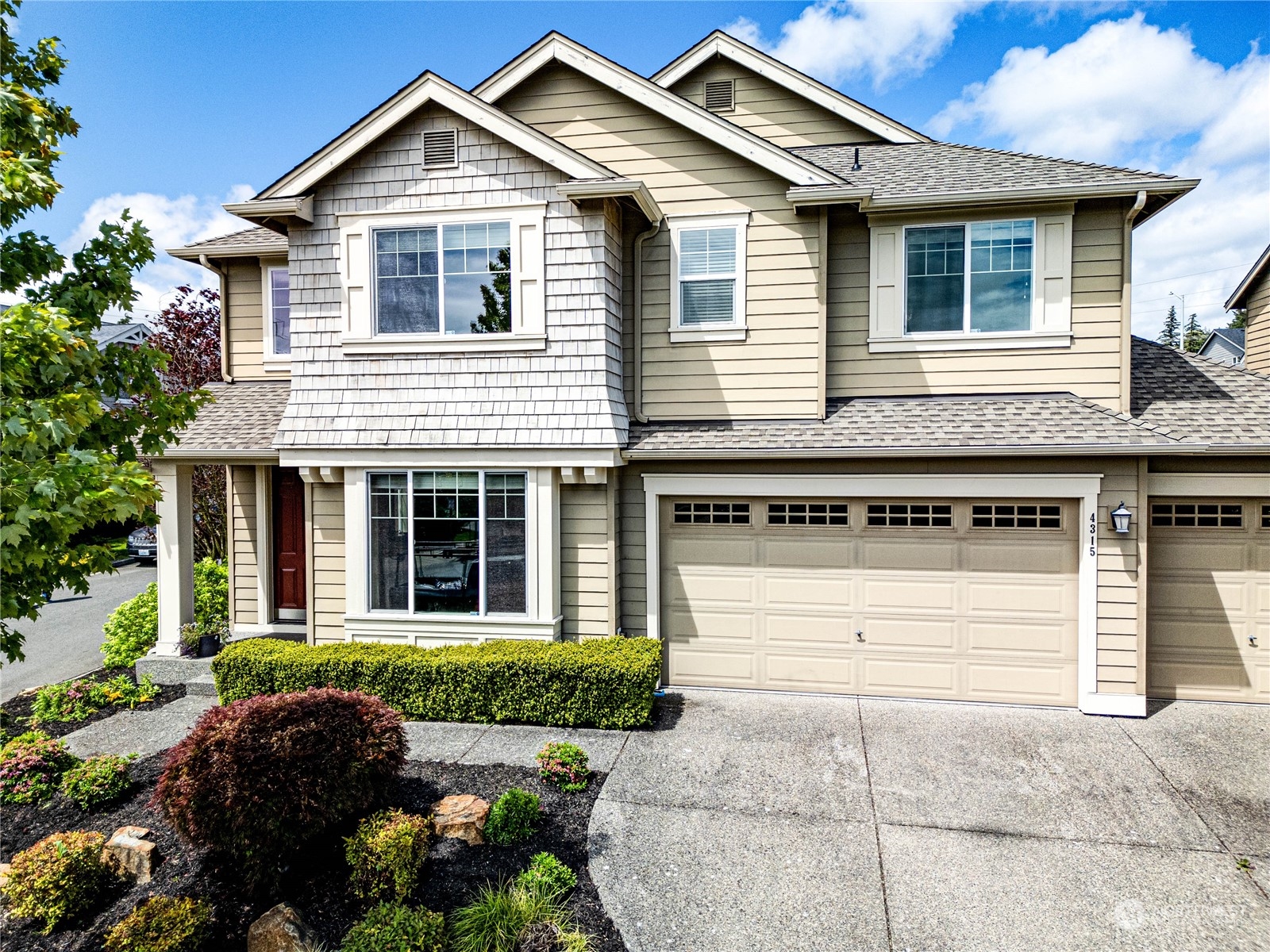 4315 229th Place Southeast Bothell, WA 98021 - Photo 2 of 40 a front view of a house with a yard and garage
